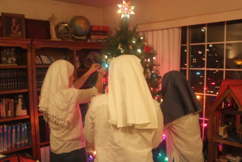 sisters decorate the christmas tree