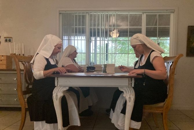 sisters reading at the table